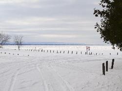 A winter landscape view of Wasaga Beach, the Blue Mountains and the Collingwood Terminals Limited Grain Elevator.  Photo was taken from the beach area 6 location of Wasaga Beach, across a frozen Georgian Bay.